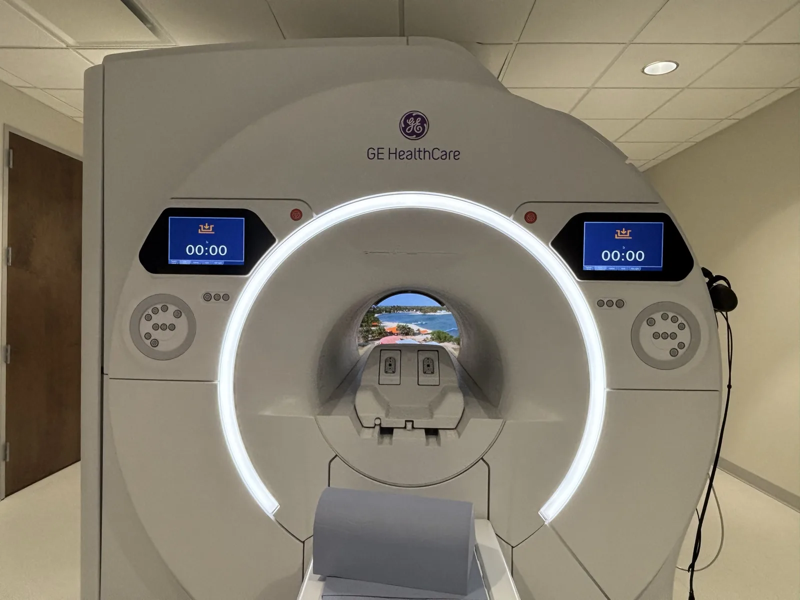 A GE scanner with MRItv showing through the bore