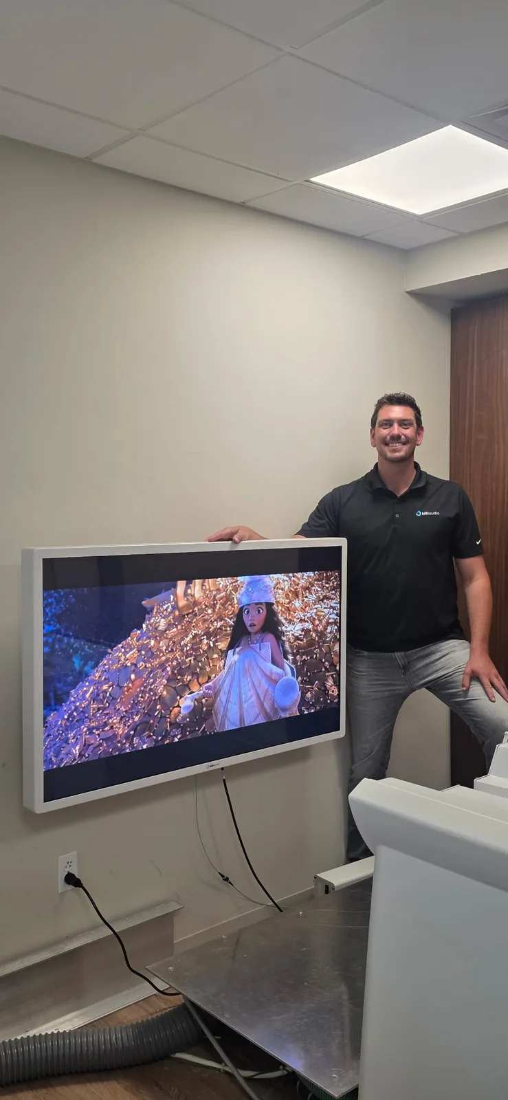 Spencer Howe, our CEO, beside a newly installed MRItv 4K Pro