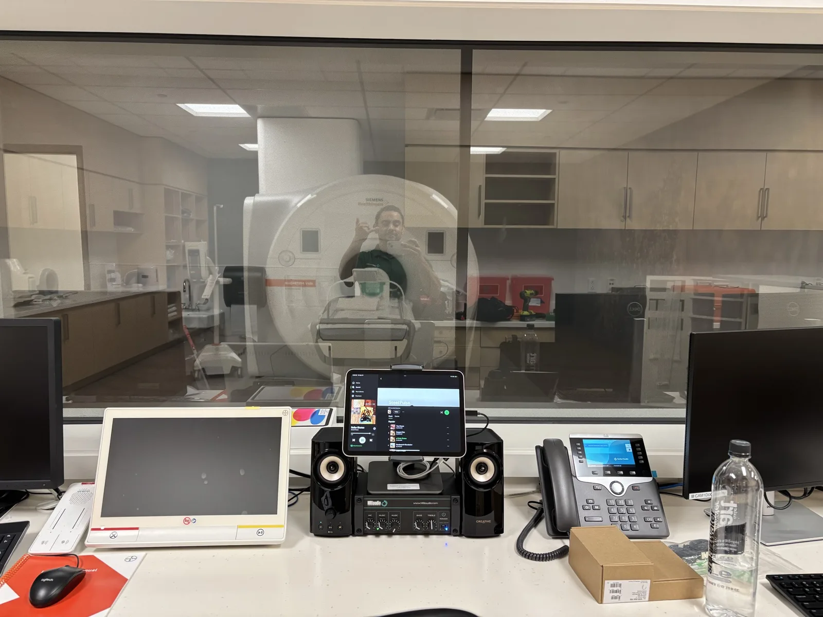 The Premium Sound System at the technologist's desk, the scanner through the window
