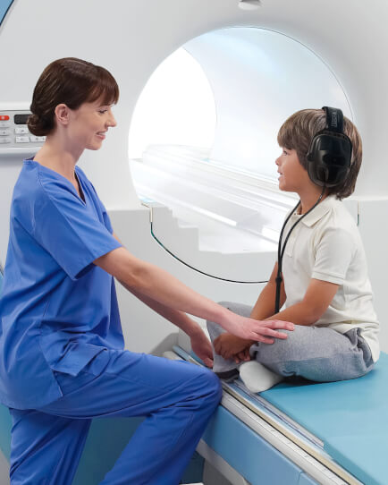 technologist using MRI audio sound system with patient